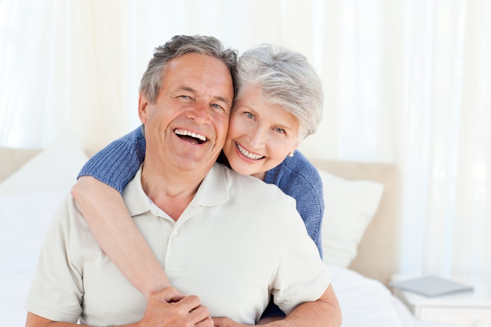 Senior couple looking at the camera  at home-1